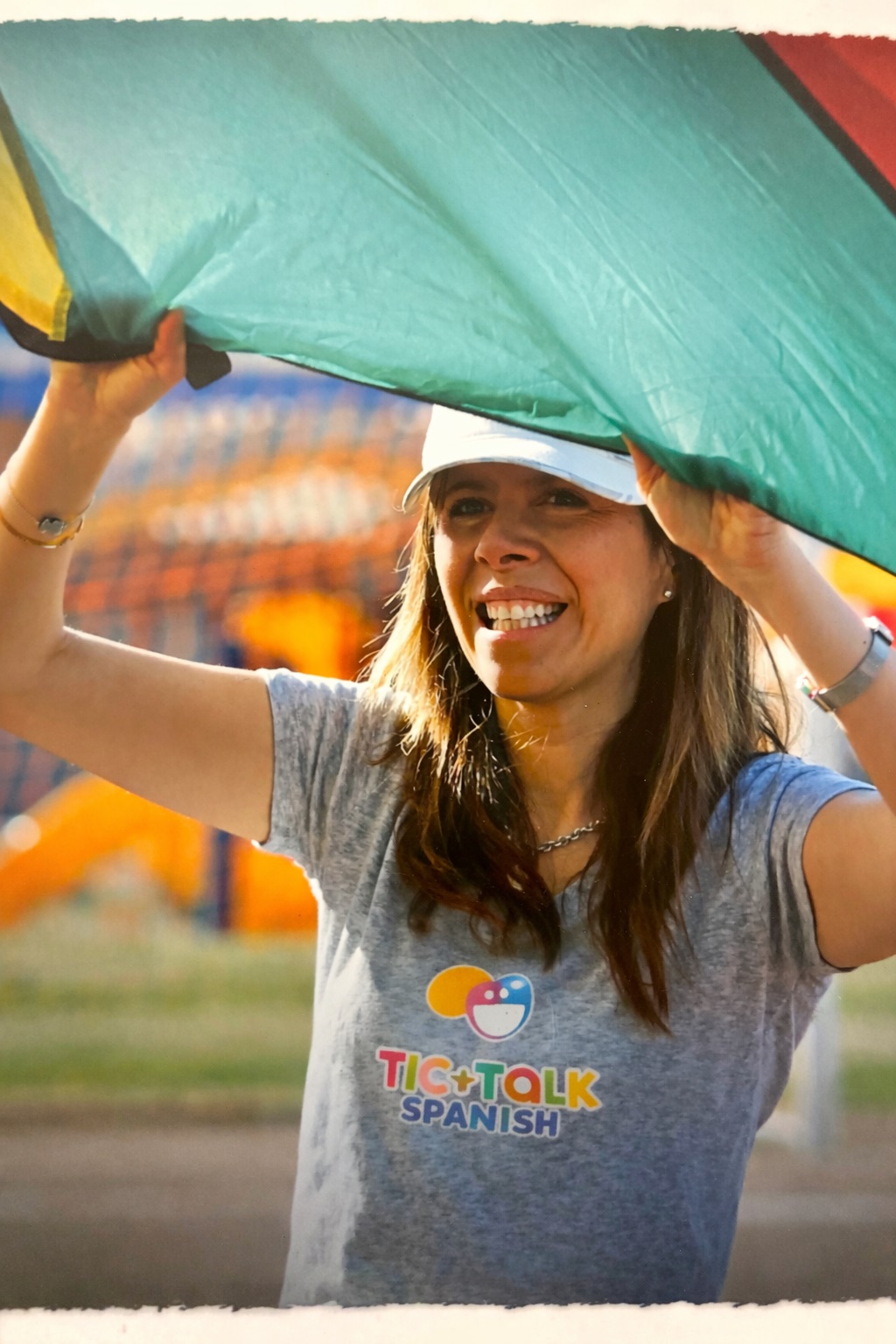 Pilar Kelley, founder of TicTalk Spanish, smiling and engaging in an outdoor immersion activity.